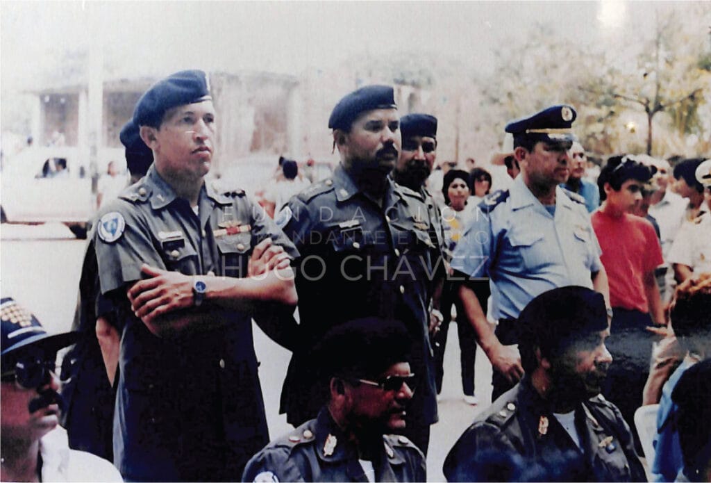 El capitán Chávez, de pie, primero de izquierda a derecha, en un acto público. Entre 1985 y 1986